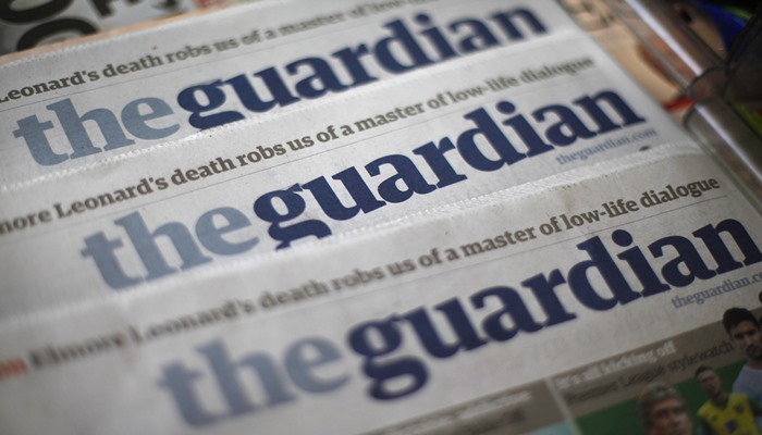 Copies of the Guardian newspaper are displayed at a news agent in London